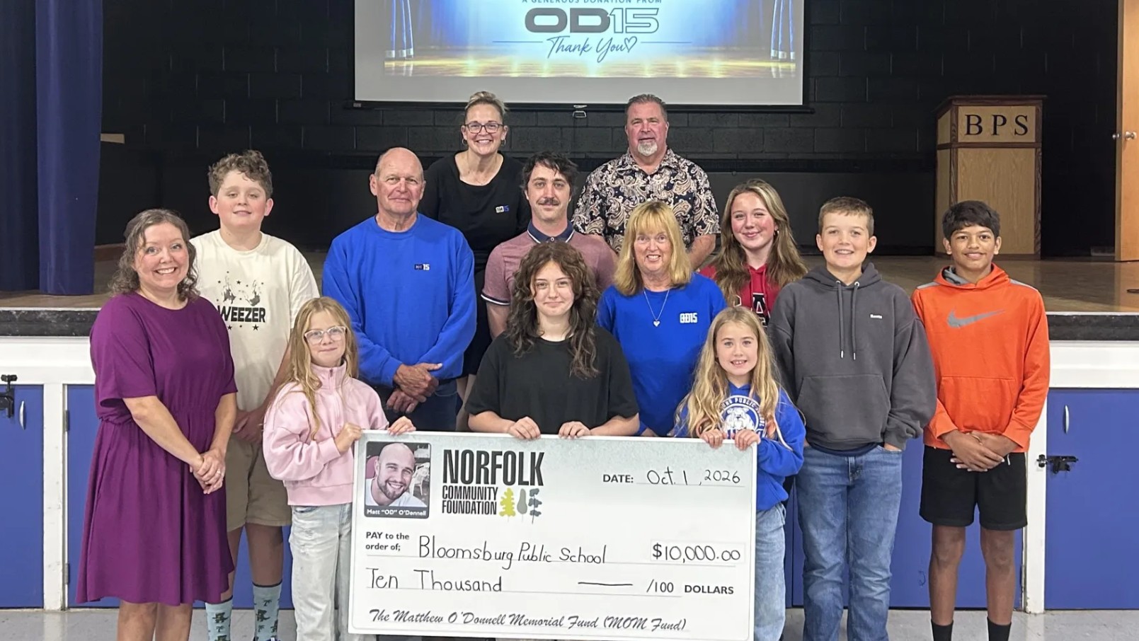 BPS staff and students smiling with representatives of Matthew ODonnell Memorial Fund