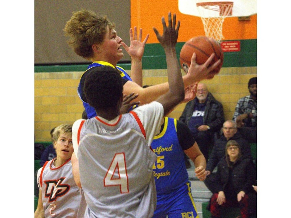 Brantford Collegiate Institute's Garrett Young drives past North Park Collegiate's Omari Barnes during AABHN senior boys basketball action at NPC on Thursday.