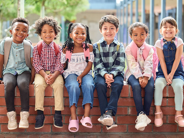 Children sitting nicely on a bench