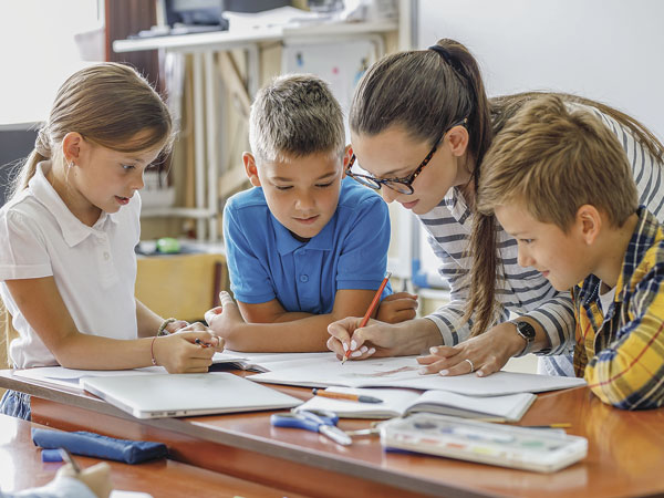 Students working with a teacher