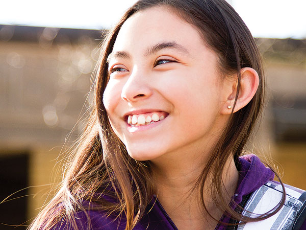 Student outdoors smiling