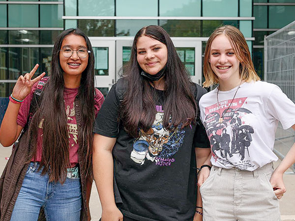 Happy Students stand outside