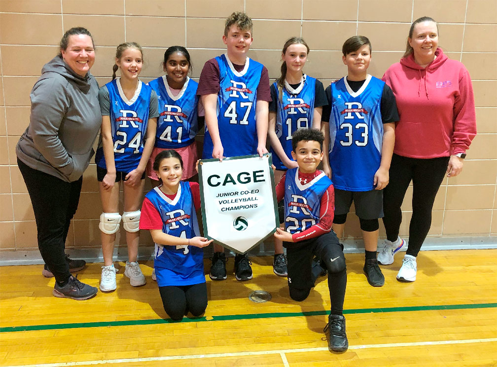 Students hold a CAGE Junior CO-ED Volleyball Champions Pendent