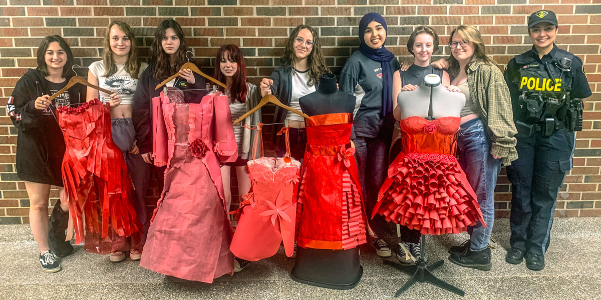 Visual arts students from Paris District High School present their works with Brant County OPP, which displayed the Red Dress project.