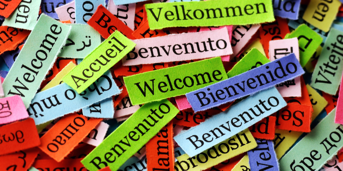 Collage of slips of paper with Welcome in different languages Collage of slips of paper with Welcome in different languages