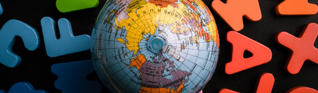 Aerial view of globe with alphabet letters scattered around it