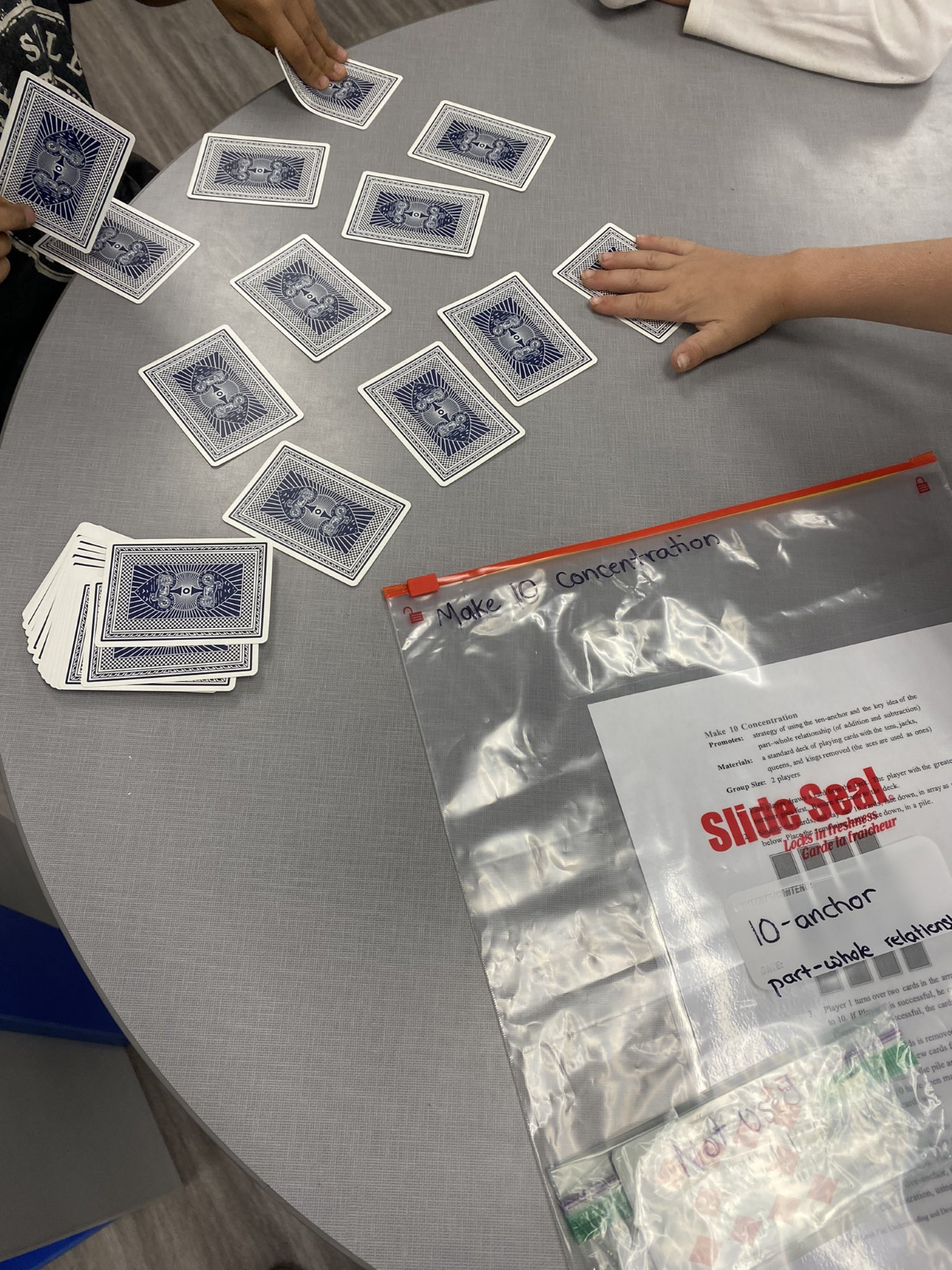 a hand holding a card over a table