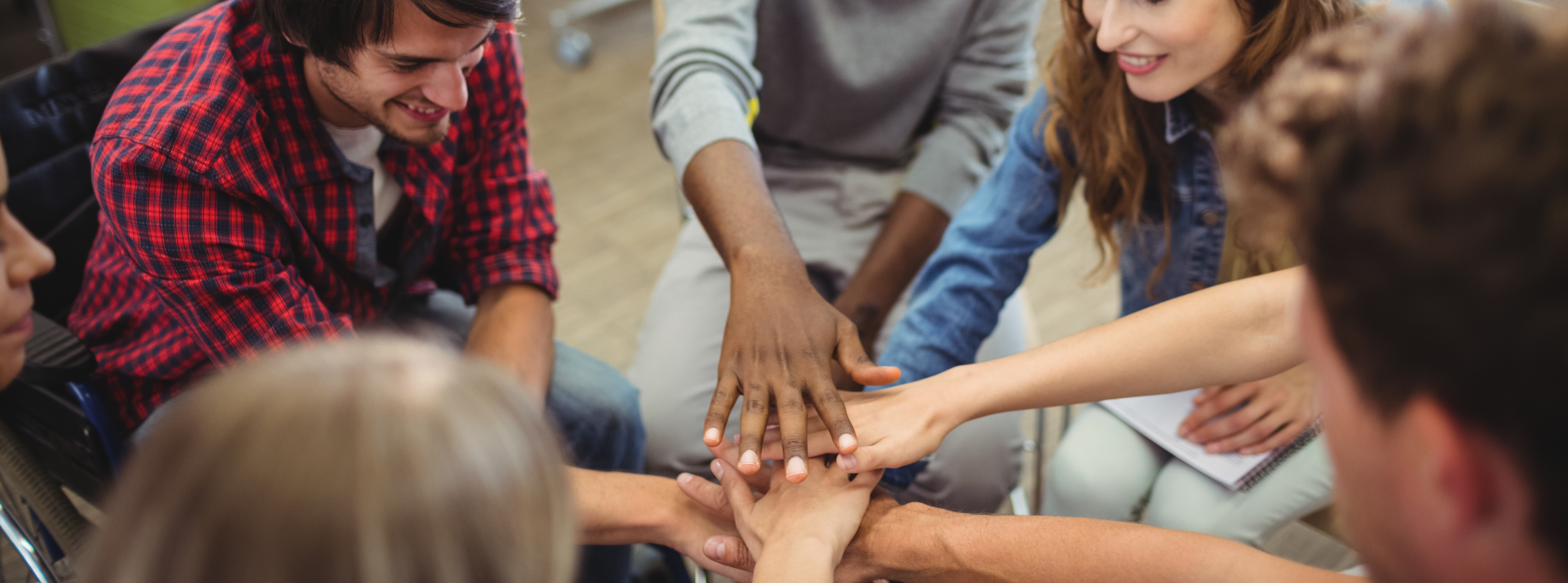 group of students holding hands together