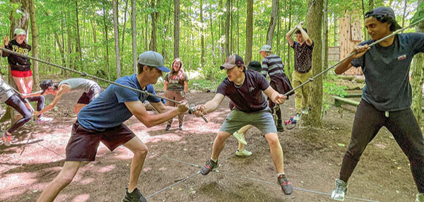 kids holding ropes in the woods