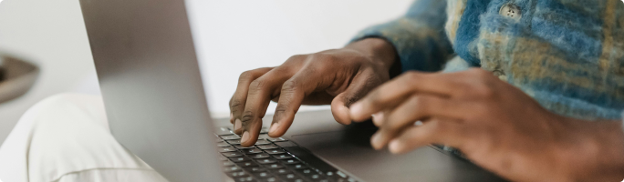 a laptop and fingers are on the keyboard