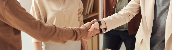 there are four people shake their hands