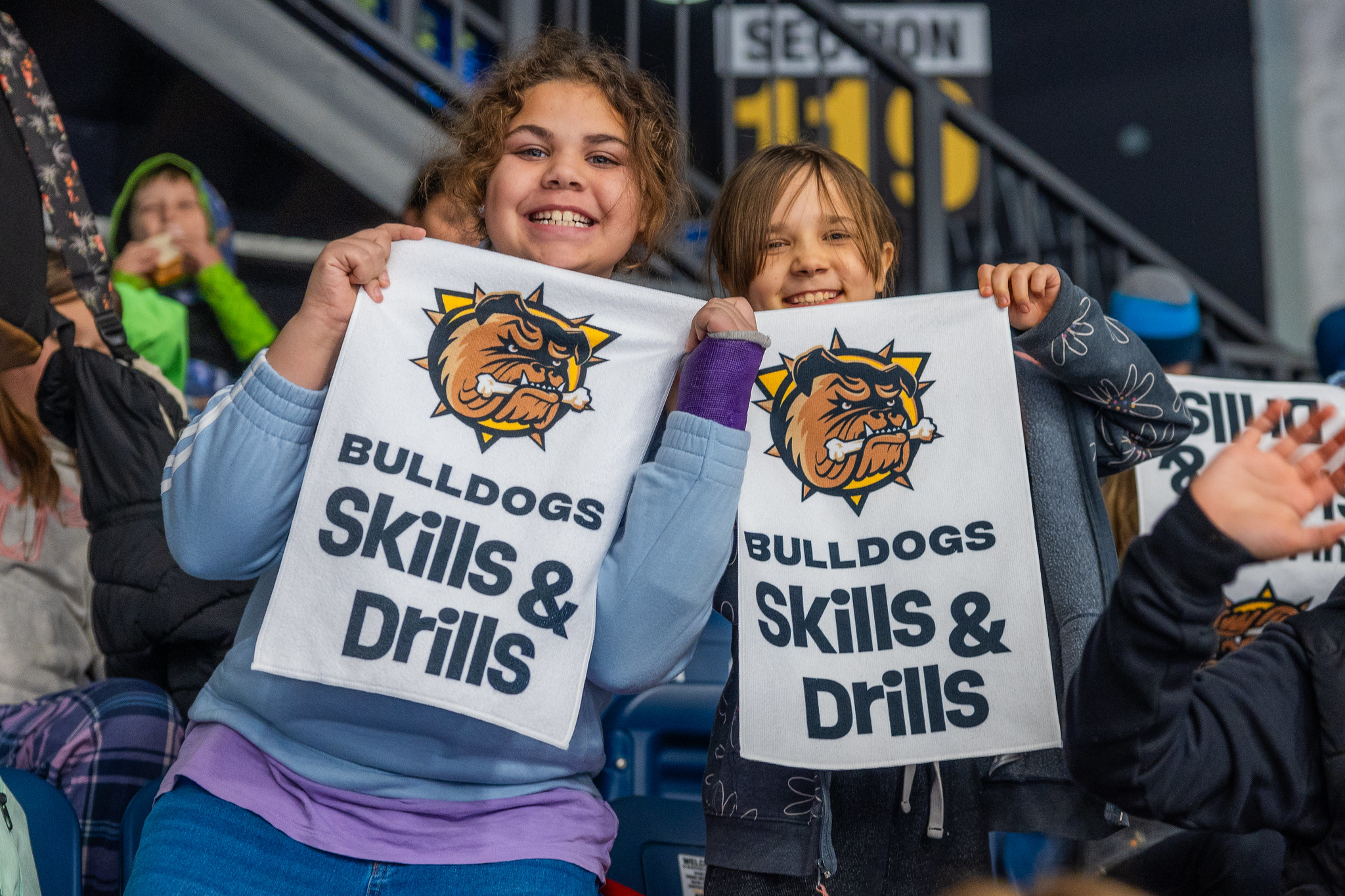 Two students holding up rally towels at the Bulldogs Skills Competition.