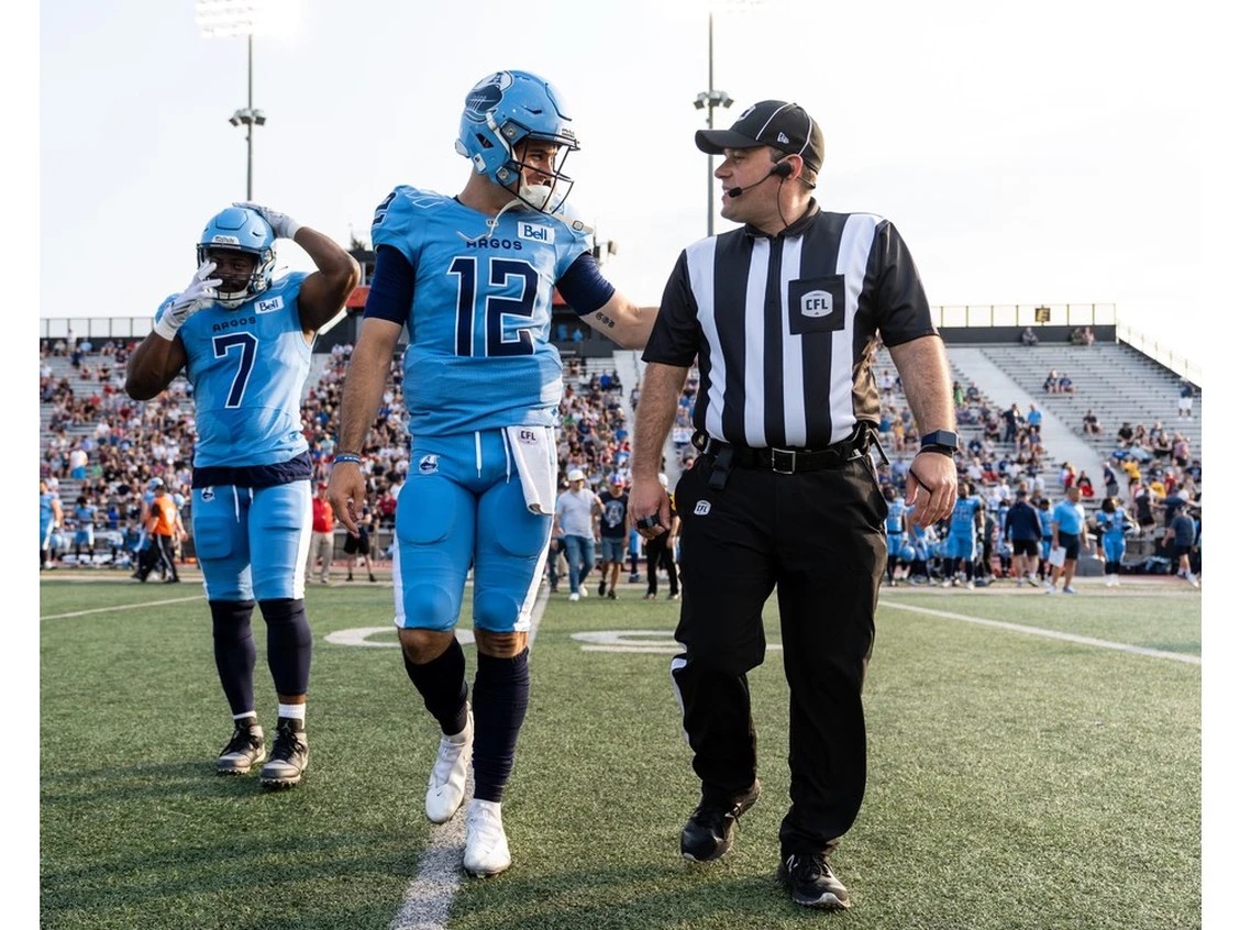 1120-br-cobb1.br_ Brantford resident Marc Cobb, with Toronto Argonauts quarterback Chad Kelly, recently officiated in the CFL's Grey Cup.