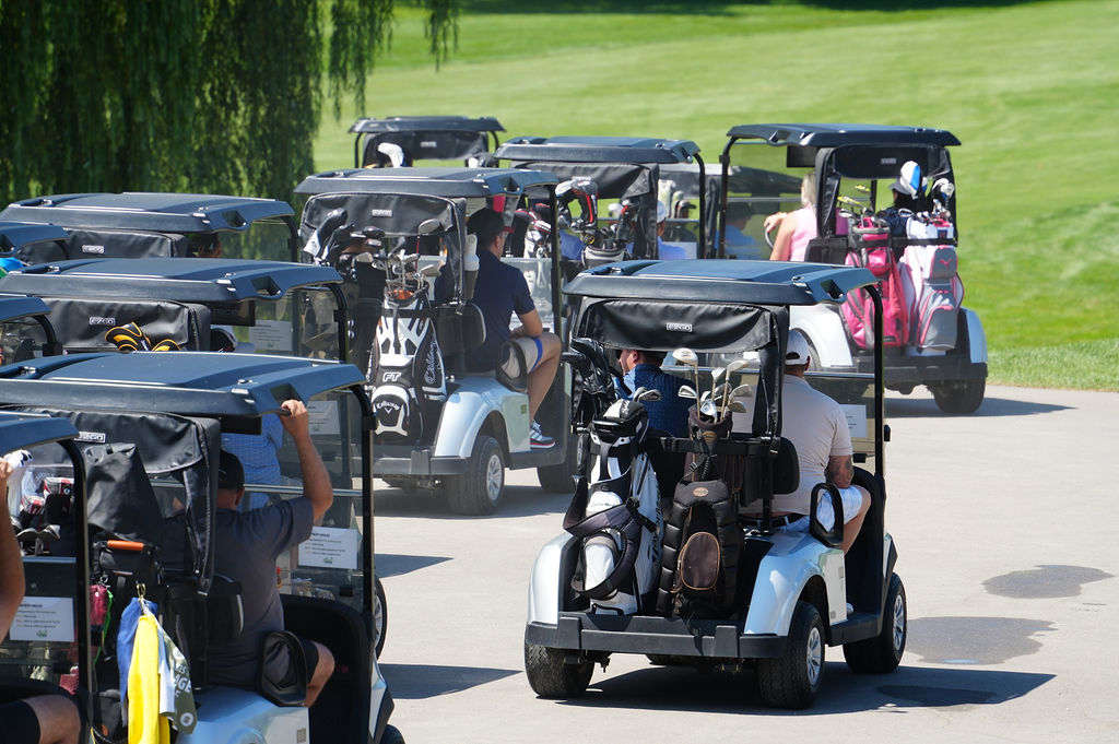 People riding in golf carts