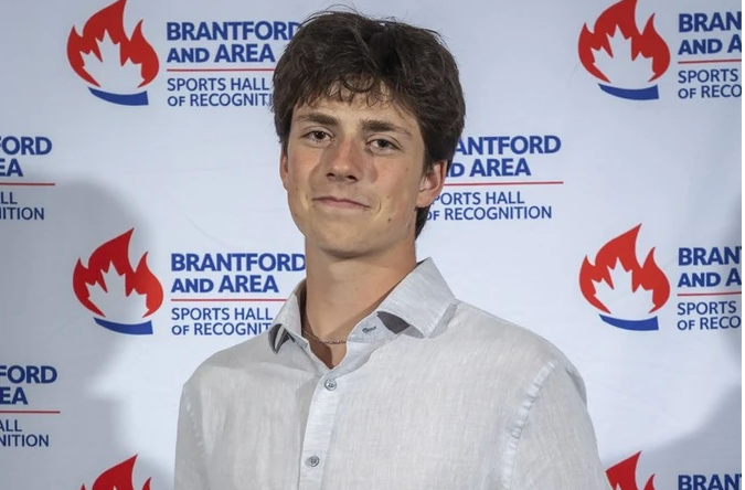 Screenshot 2026-06-17 at 10.11.42 AM Paris District High School's Canaan Sherbino posing for a photo holding Ed O'Leary Memorial Award plaque as Brant County's top male high school student athlete.