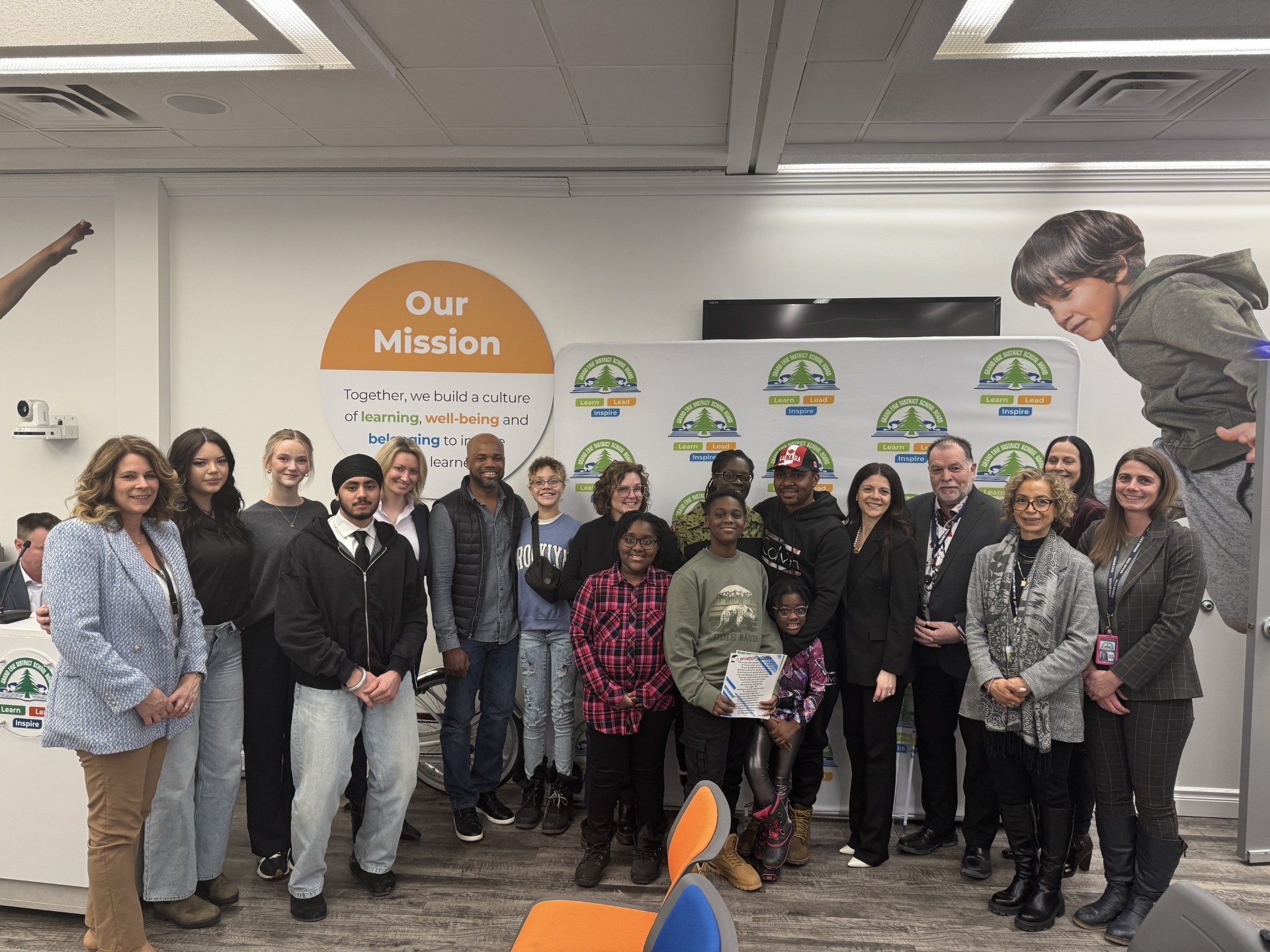 A group of students, families and administrators showcasing poetry from Words Matter Day