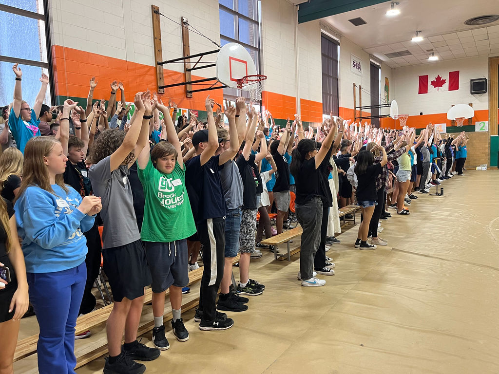 Students standing in a gym