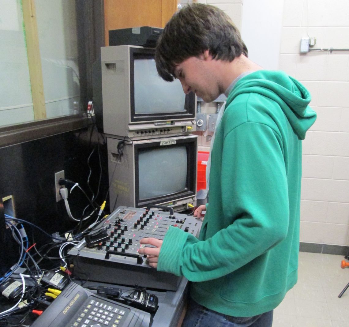 Student working at a mixing board