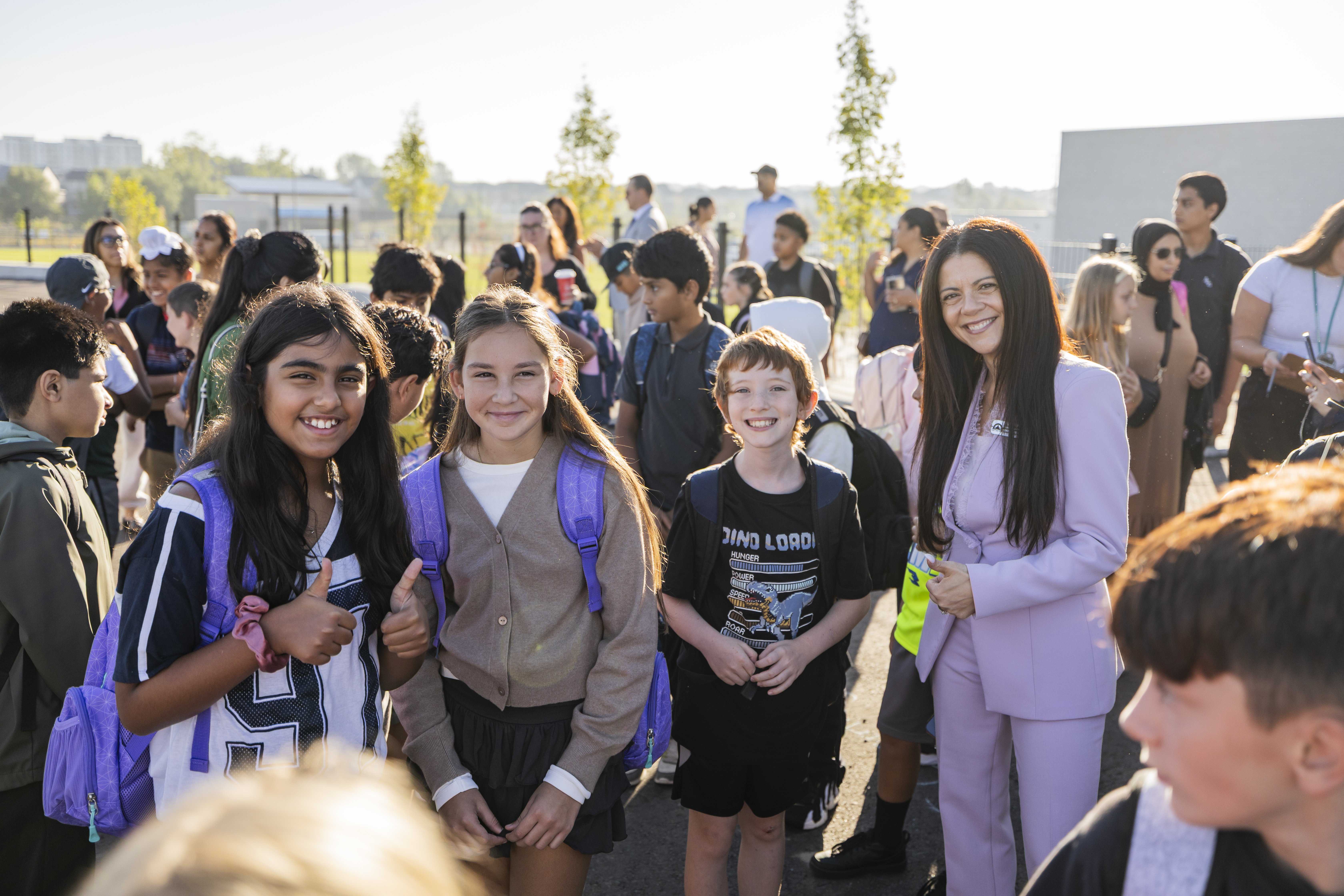 Dr. Roberto with students outside Blanche E. Williams