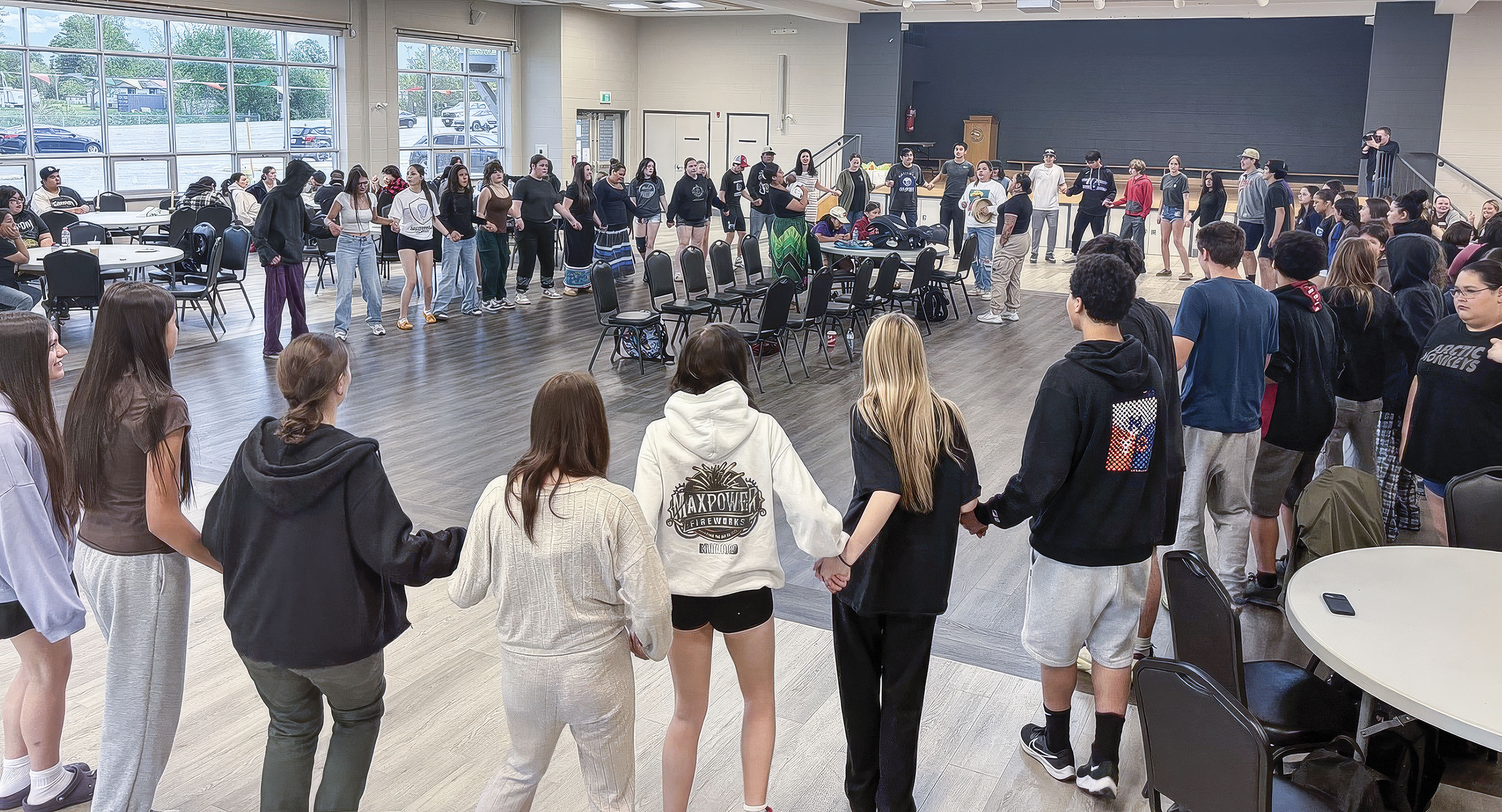 Students in circle holding hands