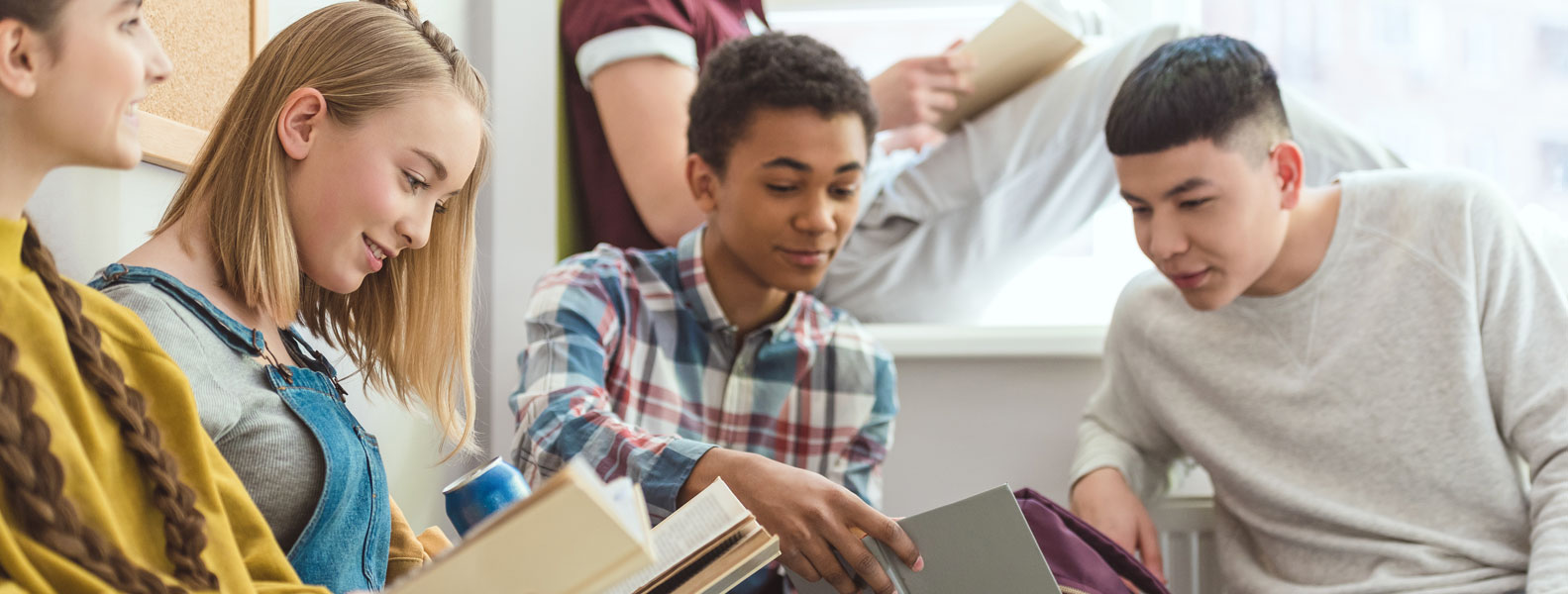 a group of kids reading books