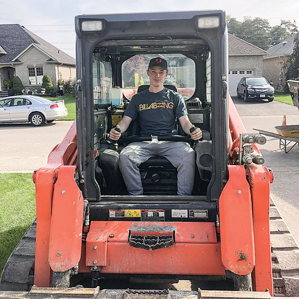 student riding heavy machinery